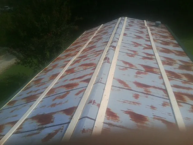 Rusted metal roof panels with new wood purlins before replacement — Storm Damage Roof Repair in South Salem by Roofing Brothers