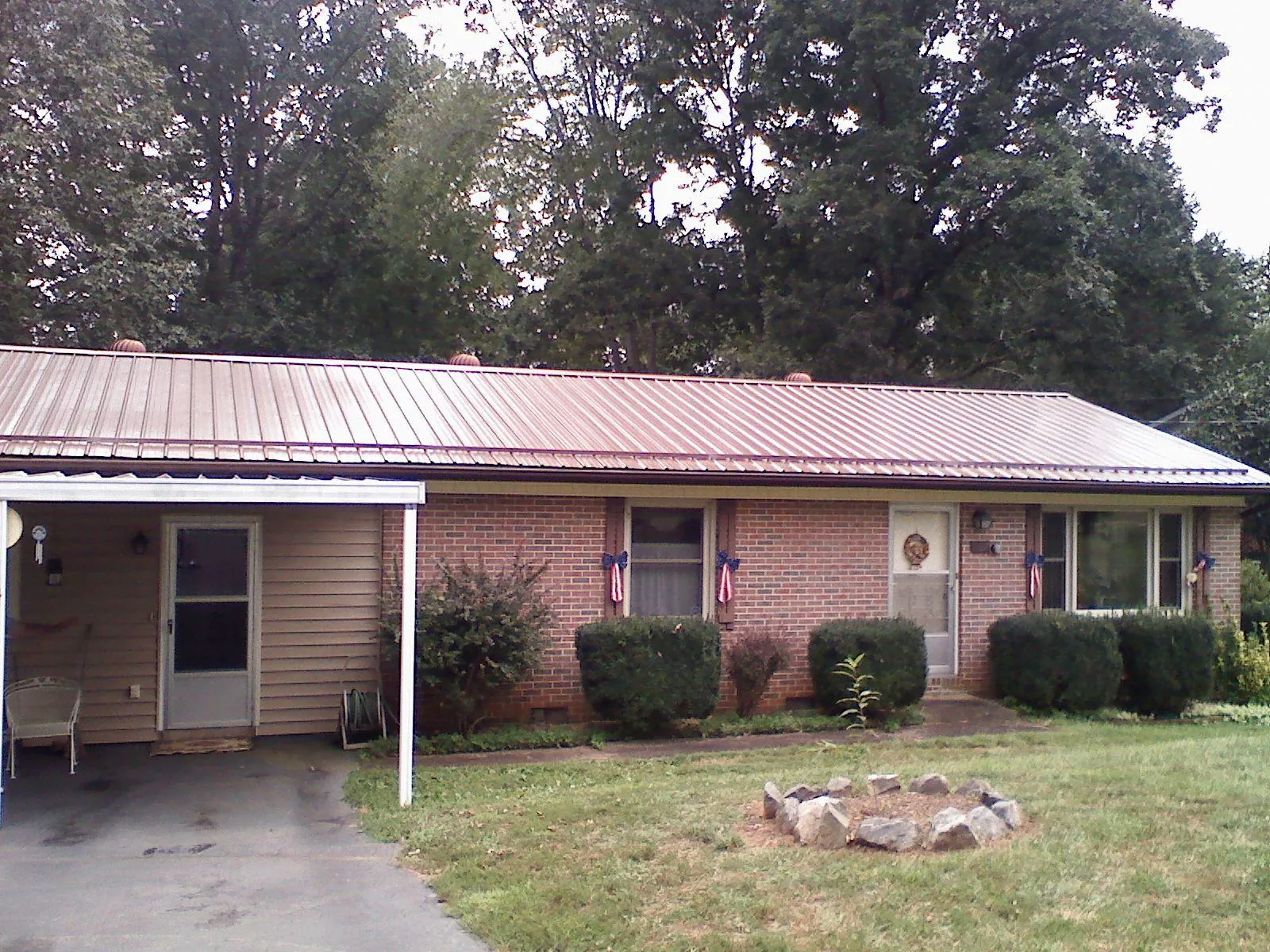 Bronze metal roof and carport on a brick ranch home — Roof Repair work by our crew in South Salem