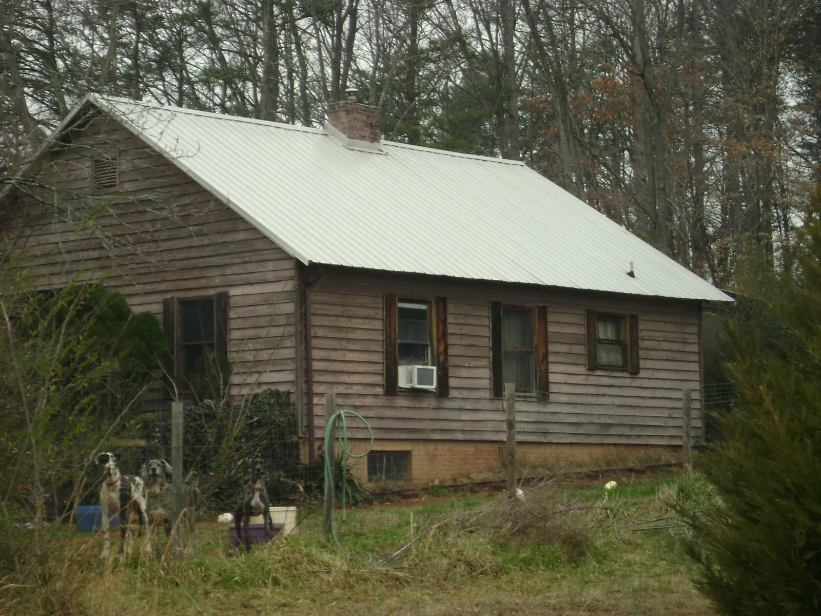 White metal roof on an old wood sided farmhouse, from a Asphalt Shingle Roof Repair job in South Salem